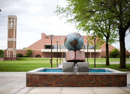 Bolivar campus forum with globe water sculpture in foreground